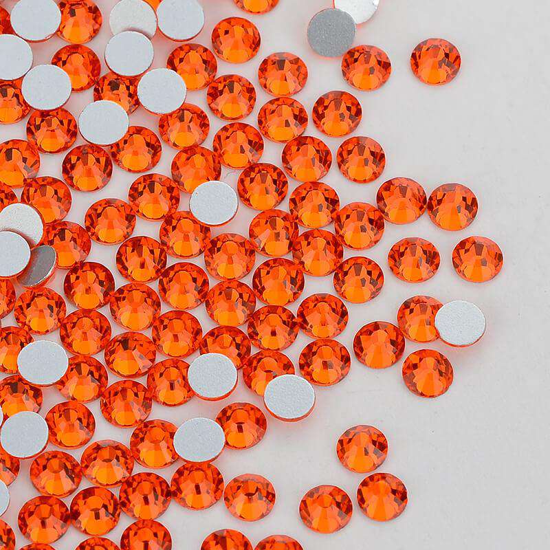 Orange rhinestones shown loose to show sparkle and cut
